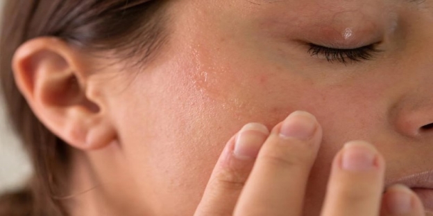 A person touching their face AI-generated content may be incorrect.