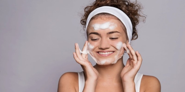 A person with white foam on her face AI-generated content may be incorrect.